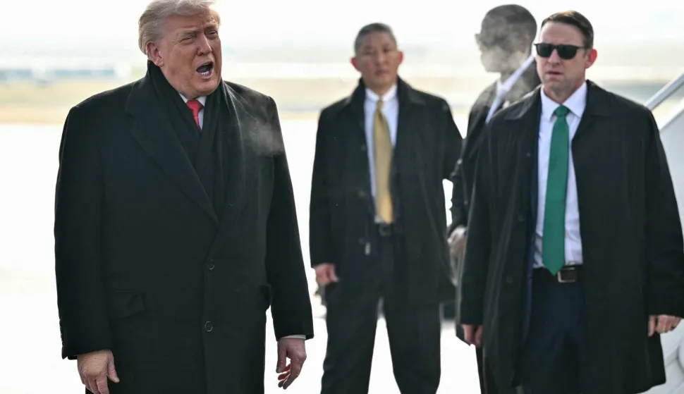 US President Donald Trump (L) reacts on the tarmac upon arrival at Zurich Airport on January 21, 2026. The World Economic Forum takes place in Davos from January 19 to January 23, 2026. (Photo by Mandel NGAN/AFP)