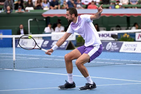 Croatia's Marin Cilic hits a return to USA's Learner Tien during their men's singles match at the Kooyong Classic tennis tournament in Melbourne on January 14, 2026. (Photo by William WEST/AFP)/-- IMAGE RESTRICTED TO EDITORIAL USE - STRICTLY NO COMMERCIAL USE --