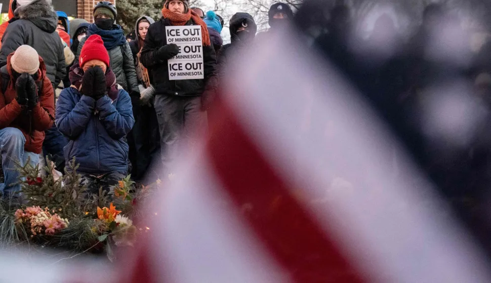 People mourn at a makeshift memorial in the area where 37-year-old Alex Pretti was shot dead by federal immigration agents earlier in the day in Minneapolis, Minnesota, on January 24, 2026. Federal immigration agents shot dead a man in Minneapolis on Saturday, in the second fatal shooting of a civilian during the Trump administration's unprecedented operation in the city, sparking fresh protests and outrage from state officials. The death came less than three weeks after US citizen Renee Good was shot and killed by an ICE officer. (Photo by ROBERTO SCHMIDT/AFP)
