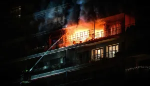 Firefighters extinguish a fire located in a flat in an apartment building, in the La Croix-Rousse neighbourhood, in central Lyon, eastern France, on January 22, 2026. (Photo by OLIVIER CHASSIGNOLE/AFP)