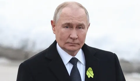 In this pool photograph distributed by the Russian state agency Sputnik, Russia's President Vladimir Putin attends a wreath-laying ceremony at the monument 'Motherland' at the Piskaryovskoye Memorial Cemetery in Saint Petersburg on January 27, 2026, marking the 82nd anniversary of the liberation of Leningrad from Nazi blockade in World War Two. (Photo by Alexander KAZAKOV/POOL/AFP)