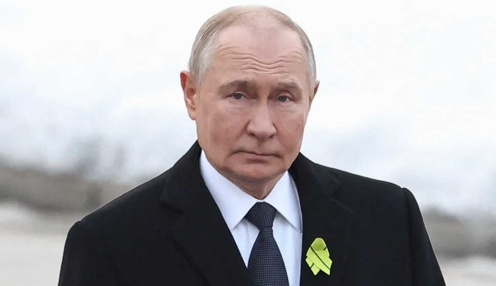 In this pool photograph distributed by the Russian state agency Sputnik, Russia's President Vladimir Putin attends a wreath-laying ceremony at the monument 'Motherland' at the Piskaryovskoye Memorial Cemetery in Saint Petersburg on January 27, 2026, marking the 82nd anniversary of the liberation of Leningrad from Nazi blockade in World War Two. (Photo by Alexander KAZAKOV/POOL/AFP)