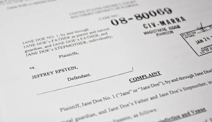 This photo illustration taken in Washington, DC, on December 19, 2025 shows a court document after the US Justice Department began releasing the long-awaited records from the investigation into the politically explosive case of convicted sex offender Jeffrey Epstein. (Photo by Mandel NGAN/AFP)