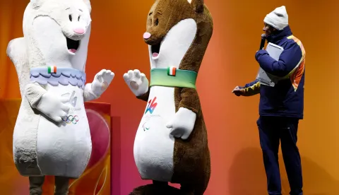 (FILES) Milo (R) and Tina, the mascots of the Milano Cortina Olympic and Paralympic Games stand on stage in Cortina d'Ampezzo before the last torch relay of the Olympic flame in the city, on January 26, 2026. (Photo by Odd ANDERSEN/AFP)