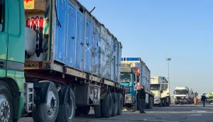 Trucks transporting portable toilets and humanitarian aid wait to enter through the Egyptian side of the Rafah border crossing with the Gaza Strip in northeastern Egypt on February 1, 2026. Israel partially reopened the Rafah crossing between the devastated Gaza Strip and Egypt on February 1, following months of urging from humanitarian organisations, though access is limited to the movement of people. (Photo by AFP)