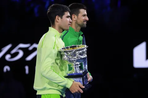 Spain's Carlos Alcaraz (front) poses with the Norman Brookes Challenge Cup after winning the men's singles final match against Serbia's Novak Djokovic on day fifteen of the Australian Open tennis tournament in Melbourne on February 1, 2026. (Photo by DAVID GRAY/AFP)/-- IMAGE RESTRICTED TO EDITORIAL USE - STRICTLY NO COMMERCIAL USE --