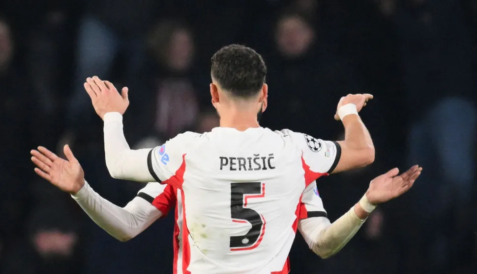 PSV Eindhoven's Moroccan midfielder #34 Ismael Saibari (unseen) celebrates with PSV Eindhoven's Croatian forward #05 Ivan Perisic after scoring his team's first goal during the UEFA Champions League league phase day 8 football match between PSV Eindhoven and Bayern Munich at Philips Stadion in Eindhoven on January 28, 2026. (Photo by JOHN THYS/AFP)