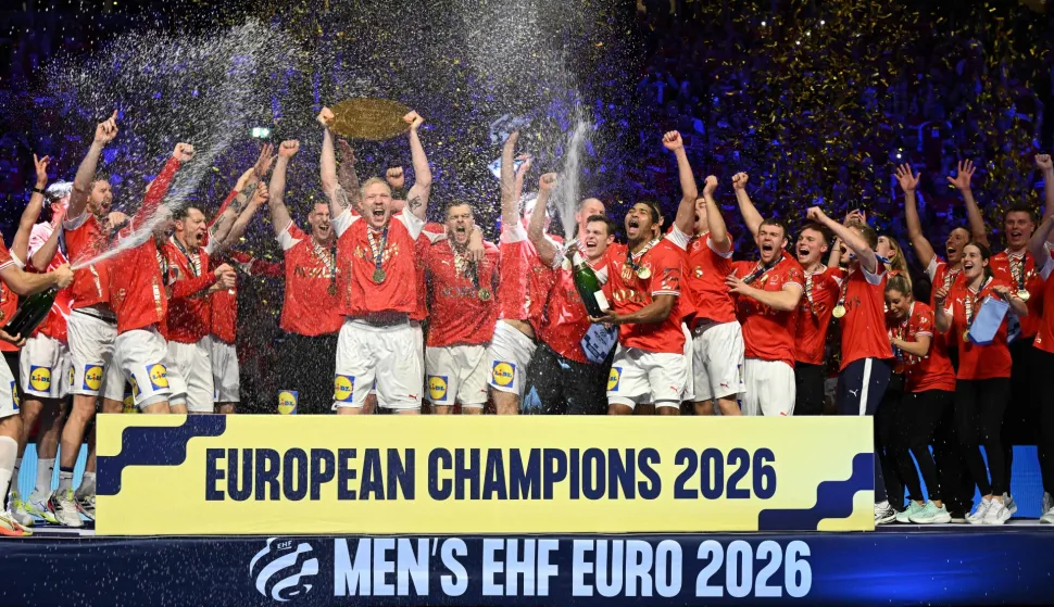 Denmark's team celebrates with the trophy after winning the Men's EHF Euro 2026 final handball match Denmark vs Germany in Herning, Denmark, on February 1, 2026. (Photo by Jonathan Nackstrand/AFP)