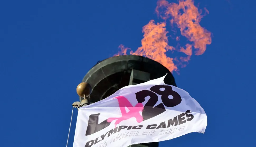 The LA28 Olympic cauldron is lit during a ceremonial lighting at the Memorial Coliseum in Los Angeles on January 13, 2026, ahead of the launch of ticket registration for the 2028 Summer Olympic Games. (Photo by Frederic J. Brown/AFP)