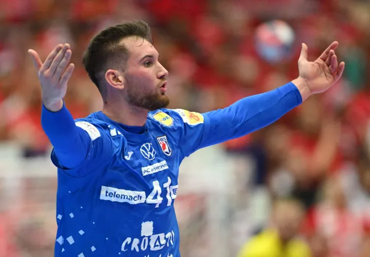 Croatia's centre back #41 Tin Lucin celebrates after scoring during the men's EHF Euro 2026 third place handball match Iceland vs Croatia in Herning, Denmark, on February 1, 2026. (Photo by Jonathan Nackstrand/AFP)