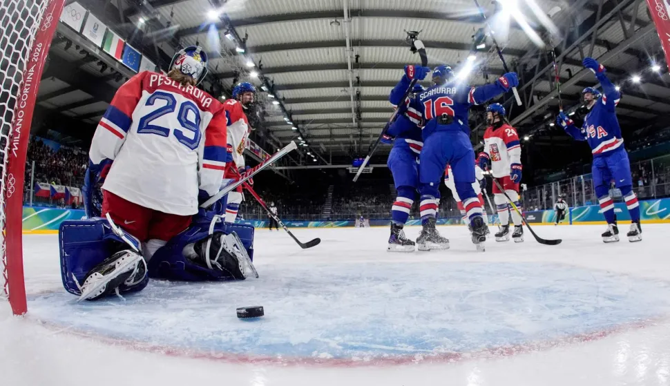 US' forward #16 Hayley Scamurra celebrates with teammates after scoring her team's fifth goal past Czech Republic's goalkeeper #29 Klara Peslarova during the women's preliminary round Group A Ice Hockey match between USA and Czech Republic at the Milano Rho Ice Hockey Arena during the Milano Cortina 2026 Winter Olympic Games in Milan, on February 5, 2026. (Photo by POOL/AFP)