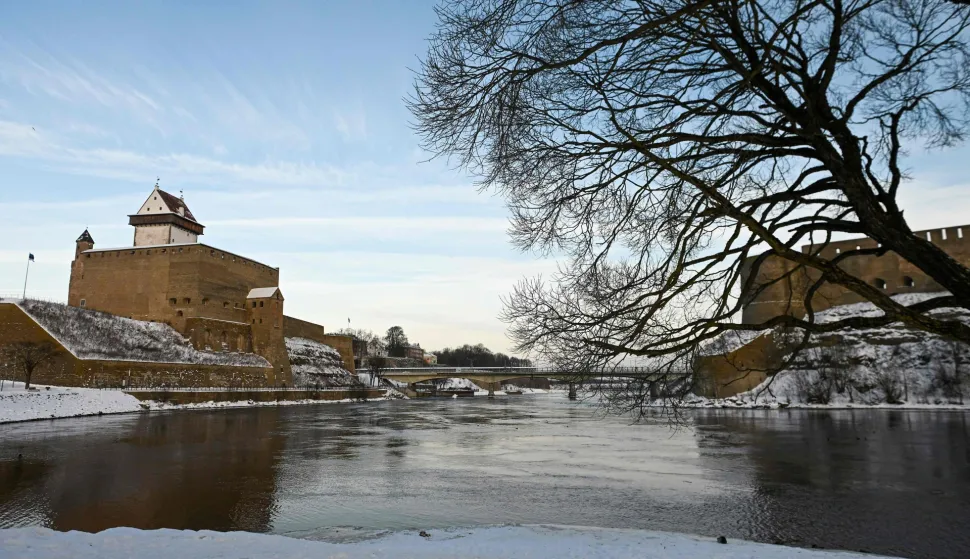 The Narva castle (L) and the Ivangorod Fortress are pictured from the river side Narva, on January 17, 2026. Two medieval fortresses face each other across the Narva River separating Estonia from Russia on Europe's eastern edge. Once a symbol of cooperation, the "Friendship Bridge" connecting the two snow-covered banks has been reinforced with rows of razor wire and "dragon's teeth" anti-tank obstacles on the Estonian side. (Photo by AFP)