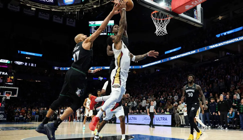 MINNEAPOLIS, MINNESOTA - FEBRUARY 06: Saddiq Bey #41 of the New Orleans Pelicans draws a foul against Anthony Edwards #5 as Rudy Gobert #27 of the Minnesota Timberwolves defends in the fourth quarter at Target Center on February 06, 2026 in Minneapolis, Minnesota. The Pelicans defeated the Timberwolves 119-115. NOTE TO USER: User expressly acknowledges and agrees that, by downloading and or using this photograph, User is consenting to the terms and conditions of the Getty Images License Agreement. David Berding/Getty Images/AFP (Photo by David Berding/GETTY IMAGES NORTH AMERICA/Getty Images via AFP)