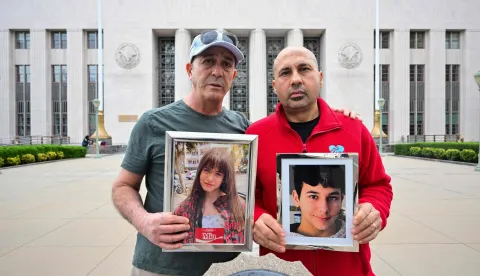 (L/R) Parents from the United Kingdom Mariano Janin, and George Nicolaou hold photos of their children outside the Los Angeles County Superior Court in Los Angeles, on February 9, 2026. Arguments are set to begin Monday in a landmark US trial that could establish a legal precedent on whether social media companies deliberately designed their platforms to lead to addiction in children. The case in Los Angeles Superior Court is being seen as a bellwether proceeding because its outcome could set the tone for a tidal wave of similar litigation across the United States. (Photo by Frederic J. Brown/AFP)