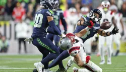 SANTA CLARA, CALIFORNIA - FEBRUARY 08: Julian Love #20 and Coby Bryant #8 of the Seattle Seahawks break up a pass intended for Mack Hollins #13 of the New England Patriots during Super Bowl LX at Levi's Stadium on February 08, 2026 in Santa Clara, California. Ronald Martinez/Getty Images/AFP (Photo by RONALD MARTINEZ/GETTY IMAGES NORTH AMERICA/Getty Images via AFP)