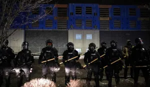Minneapolis police form a line near protestors gathered for a ?Goodbye Bovino Noise Demo? rally in front of the hotel where they believe US Customs and Border Protection Commander Gregory Bovino to be staying, in Maple Grove, in the outskirts of Minneapolis, Minnesota, on January 26, 2026. US media reported that controversial Border Patrol commander Gregory Bovino was leaving Minneapolis -- though the US Department of Homeland Security (DHS) has vehemently denied he is being let go. On January 24, federal agents shot and killed Alex Pretti, a 37-year-old ICU nurse, while scuffling with him on an icy roadway in Minneapolis, less than three weeks after an immigration officer fired on Renee Good, also 37, killing her in her car. US President Donald Trump blamed their deaths on Democratic "chaos," as his administration faced intensifying pressure over its mass immigration crackdown in Minneapolis. (Photo by ROBERTO SCHMIDT/AFP)