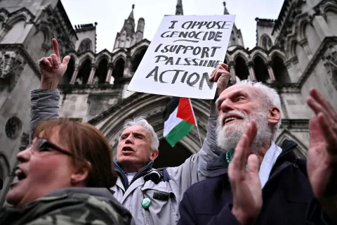 Protestors react after hearing the verdict outside The Royal Courts of Justice, Britain's High Court, in London on February 13, 2026. Palestine Action co-founder Huda Ammori won a legal challenge February 13, 2026, against a UK government ban on the activist group that has led to mass arrests and concerns over free speech and civil liberties. The government proscribed the group last July, days after activists protesting the war in Gaza broke into an air force base in southern England and caused millions of pounds worth of damage to two aircraft. (Photo by Ben STANSALL/AFP)