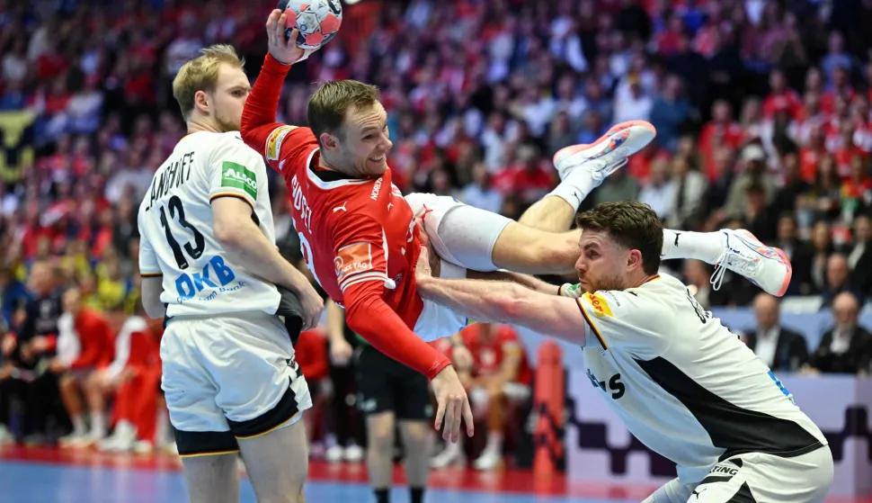 Denmark's right back #19 Mathias Gidsel (L) is tackled by Germany's pivot #04 Johannes Golla during the Men's EHF Euro 2026 final handball match Denmark vs Germany in Herning, Denmark, on February 1, 2026. (Photo by Jonathan Nackstrand/AFP)