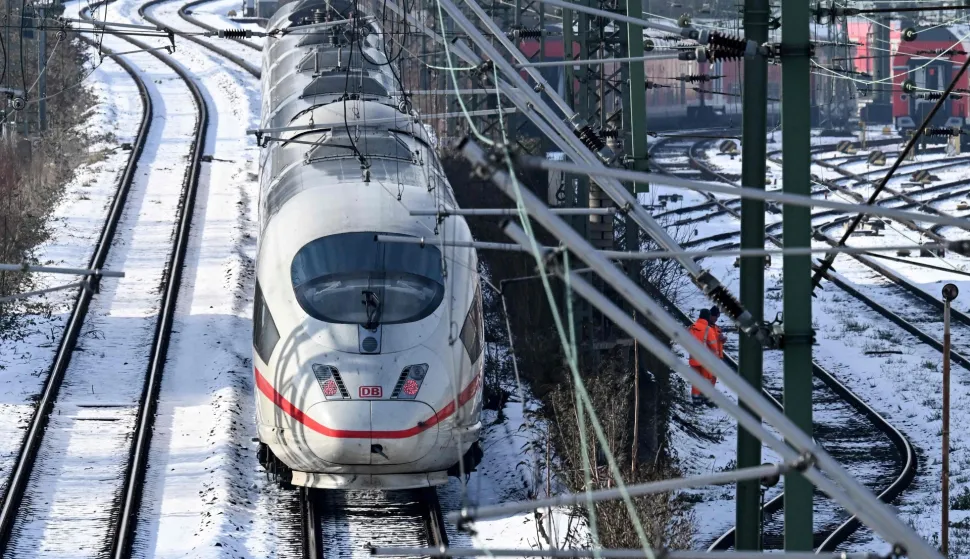 ICE high speed train drives on the snow-covered lines outside main railway station in Frankfurt am Main, western Germany, on January 27, 2026 as the air temperature reached 3 degrees Celsius above zero. (Photo by Kirill KUDRYAVTSEV/AFP)
