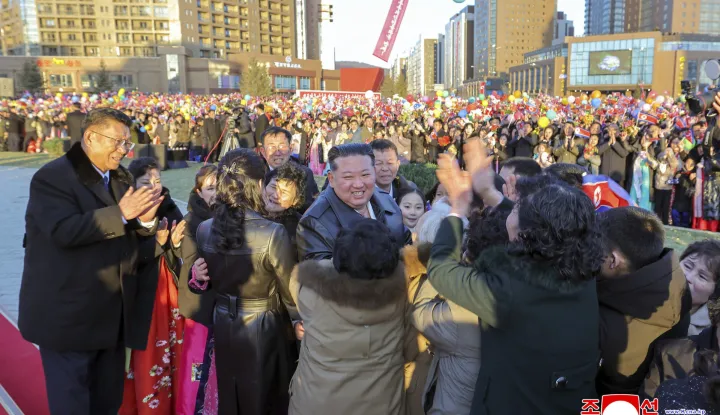 This picture taken on February 16, 2026 and released by North Korea's official Korean Central News Agency (KCNA) on February 17, 2026 shows North Korean leader Kim Jong Un (C) congratulating residents moving into their new homes at the inauguration ceremony of 10,000 flats at fourth stage in Hwasong area of Pyongyang. (Photo by KCNA VIA KNS/AFP)/South Korea OUT/---EDITORS NOTE--- RESTRICTED TO EDITORIAL USE - MANDATORY CREDIT "AFP PHOTO/KCNA VIA KNS" - NO MARKETING NO ADVERTISING CAMPAIGNS - DISTRIBUTED AS A SERVICE TO CLIENTSTHIS PICTURE WAS MADE AVAILABLE BY A THIRD PARTY. AFP CAN NOT INDEPENDENTLY VERIFY THE AUTHENTICITY, LOCATION, DATE AND CONTENT OF THIS IMAGE./