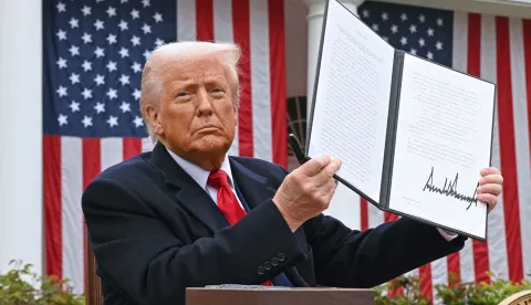 (FILES) US President Donald Trump holds a signed executive order after delivering remarks on reciprocal tariffs during an event in the Rose Garden entitled "Make America Wealthy Again" at the White House in Washington, DC, on April 2, 2025. The US Supreme Court ruled on February 20, 2026 that Donald Trump exceeded his authority in imposing a swath of tariffs that upended global trade, blocking a key tool the president has wielded to impose his economic agenda. (Photo by SAUL LOEB/AFP)