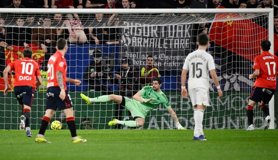Osasuna's Croatian forward #17 Ante Budimir (R) scores the opening goal from the penalty spot during the Spanish league football match between CA Osasuna and Real Madrid CF at El Sadar Stadium in Pamplona on February 21, 2026. (Photo by ANDER GILLENEA/AFP)