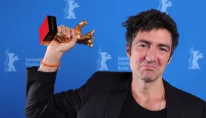 German director Ilker Catak poses during a photocall after winning the Golden Bear for Best Film for "Gelbe Briefe" (Yellow Letters) at the 76th Berlinale, Europe's first major film festival of the year, in Berlin on February 21, 2026. The 76th Berlin Film Festival draws to a close after 10 days, with 22 films in competition. (Photo by Ronny HARTMANN/POOL/AFP)