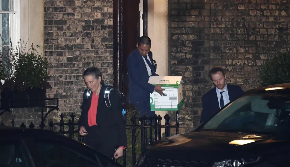 A police officer exits the residence of Former UK ambassador to the United States, Peter Mandelson, with boxes, in central London on February 6, 2025. UK police probing Mandelson were searching two properties on February 6, 2026, London's Metropolitan Police said, following fresh revelations in the Epstein files. The searches came as Prime Minister Keir Starmer faces intense scrutiny over his decision to appoint Mandelson as the country's US envoy despite his association with convicted US sex offender Jeffrey Epstein. (Photo by Henry NICHOLLS/AFP)