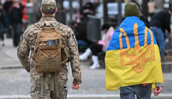 People arrive for a rally marking the 4th anniversary of Russia's full-scale invasion of Ukraine in front of Berlin's landmark Brandenburg Gate in Berlin, on February 24, 2026. (Photo by RALF HIRSCHBERGER/AFP)