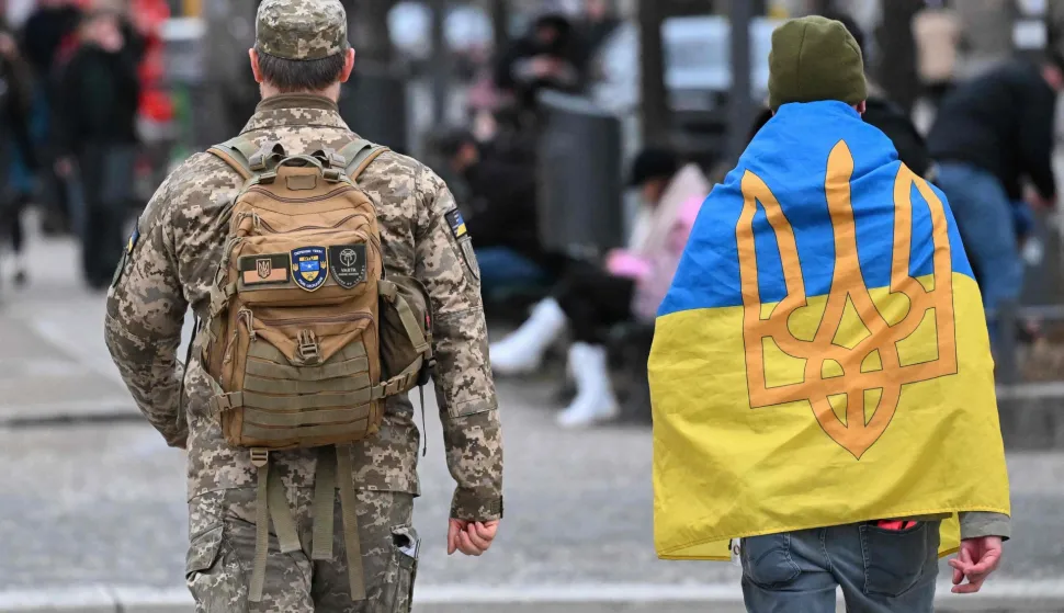 People arrive for a rally marking the 4th anniversary of Russia's full-scale invasion of Ukraine in front of Berlin's landmark Brandenburg Gate in Berlin, on February 24, 2026. (Photo by RALF HIRSCHBERGER/AFP)
