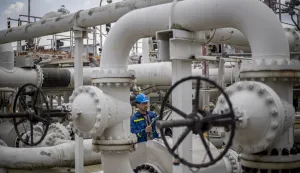 epa10122970 An employee checks control wheel on pipelines at the Central oil tank farm operated by Mero CR near Nelahozeves, Czech Republic, 15 August 2022. Mero CR owns and operates the Czech part of the Druzhba pipeline and the IKL pipeline, is the sole transporter of crude oil to the Czech Republic, and also provides storage for the Czech emergency strategic oil reserves. Both pipelines enter the Central oil tank farm near Nelahozeves, where the company has built a total of 17 oil tanks with a total storage capacity of 1 675 000 m3. In June 2022, the European Union approved a sixth package of sanctions over Russia's invasion of Ukraine, which includes a ban on most Russian oil imports from the turn of the year. Oil transport via the Druzhba pipeline supplying the Czech Republic, Slovakia and Hungary will be temporarily excluded from the embargo. EPA/MARTIN DIVISEK