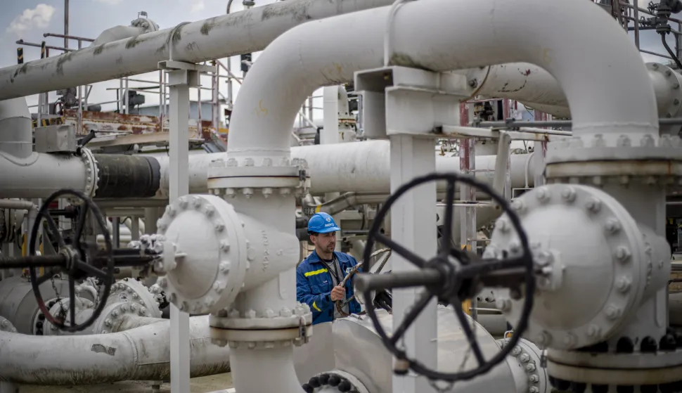 epa10122970 An employee checks control wheel on pipelines at the Central oil tank farm operated by Mero CR near Nelahozeves, Czech Republic, 15 August 2022. Mero CR owns and operates the Czech part of the Druzhba pipeline and the IKL pipeline, is the sole transporter of crude oil to the Czech Republic, and also provides storage for the Czech emergency strategic oil reserves. Both pipelines enter the Central oil tank farm near Nelahozeves, where the company has built a total of 17 oil tanks with a total storage capacity of 1 675 000 m3. In June 2022, the European Union approved a sixth package of sanctions over Russia's invasion of Ukraine, which includes a ban on most Russian oil imports from the turn of the year. Oil transport via the Druzhba pipeline supplying the Czech Republic, Slovakia and Hungary will be temporarily excluded from the embargo. EPA/MARTIN DIVISEK