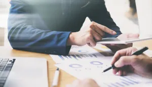 Businessman hand pointing at business document during discussion at meeting. Business analysis meeting training team.