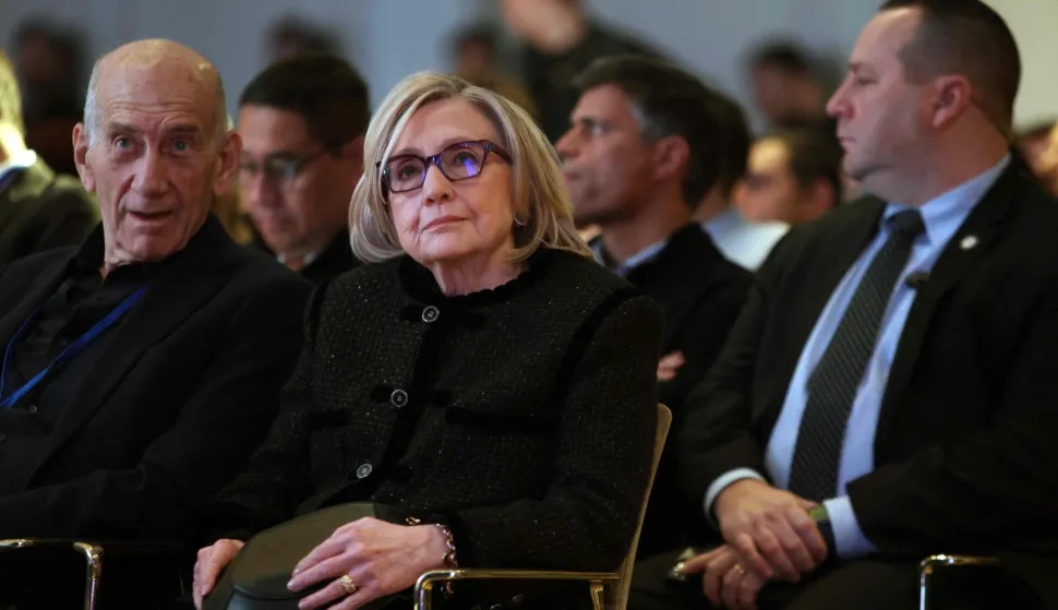 Former US Secretary of State Hillary Clinton sits nex to Former Israeli Prime minister Ehud Olmert as they attend the The World Forum 2026 on the "Future of Democracy, AI/Tech, and Humankind" as part of the "Cinema for Peace" events in Berlin, on February 16, 2026. (Photo by Adam BERRY/AFP)