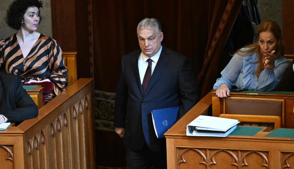 Hungary's Prime Minister Viktor Orban steps into the main hall of the parliament building prior to the spring session of the Hungarian Parliament on February 23, 2026 in Budapest, Hungary. Hungarian Prime Minister Viktor Orban is facing the toughest challenge since returning to power in 2010, with his Fidesz party trailing the opposition TISZA party in opinion polls ahead of parliamentary elections on April 12, 2026. (Photo by Attila KISBENEDEK/AFP)