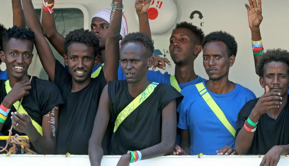 epa06951272 Migrants on board the SOS Mediterranee NGO rescue vessel MV Aquarius react as the vessel enters the Grand Harbour in Senglea, Valletta, Malta, 15 August 2018. The migrant rescue ship was allowed to dock in Malta on the day after days at sea with some 141 migrants on board - who were rescued off the Libyan coast Libya on 10 August - and since then turned away from Italian ports, media reported. Malta reached an agreement with Germany, Spain, Portugal, France and Luxembourg to allow the ship to dock before sending the migrants to the five countries. EPA/DOMENIC AQUILINA