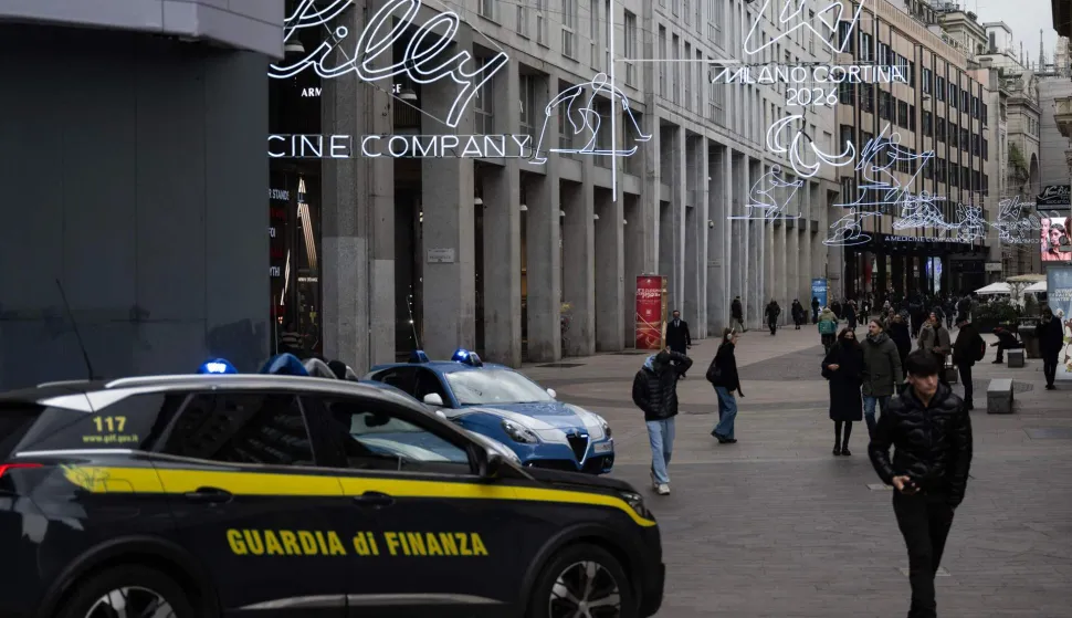 A car of the Italian Guardia di Finanza patrols in San Babila?s square ahead of Milano Cortina 2026 Olympic Games, in Milan on January 27, 2026. (Photo by MARCO BERTORELLO/AFP)