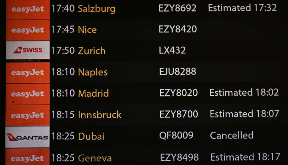 The arrivals board is seen, showing a cancelled flight from Dubai, in the north terminal at London Gatwick airport in Crawley, on February 28, 2026, following the US and Israel's strikes on Iran. Flights across the Middle East were being cancelled Saturday as several countries slammed their airspace shut after the United States and Israel launched strikes on Iran. (Photo by Ben Stansall/AFP)