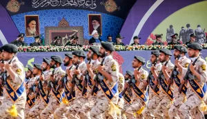 (FILES) This handout picture provided by the Iranian presidency on September 22, 2019 shows President Hassan Rouhani (C) and other top military commanders watching members the Islamic Revolutionary Guard Corps (IRGC) marching past during the annual "Sacred Defence Week" military parade marking the anniversary of the outbreak of the devastating 1980-1988 war with Saddam Hussein's Iraq, in Tehran. Iran's IRGC is the ideological army of the Islamic republic tasked with protecting the revolution from external and domestic threats but is accused by the West of militant activity abroad and serial rights violations at home. The EU is expected on January 29, 2026 to agree to list it as a terrorist organisation, matching similar classification enacted by the US, Canada, and Australia. (Photo by Iranian Presidency/AFP)/=== RESTRICTED TO EDITORIAL USE - MANDATORY CREDIT "AFP PHOTO/HO/IRANIAN PRESIDENCY" - NO MARKETING NO ADVERTISING CAMPAIGNS - DISTRIBUTED AS A SERVICE TO CLIENTS ===