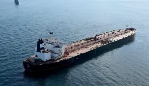 (FILES) This aerial picture taken on October 1, 2025 off the coast of the western France port of Saint-Nazaire shows the tanker Boracay from Russia's so-called "shadow fleet" suspected of being involved in drone flights over Denmark which sailed off the Danish coast between September 22 and 25, with a boat of the French Navy in the background. The Chinese captain of the Boracay tanker from Russia's so-called 'shadow fleet' intercepted off the French coast, will stand trial at Brest courthouse, western France, on February 23, 2026. (Photo by Damien MEYER/AFP)
