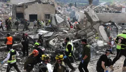 Israeli emergency service officers search the scene of a missile attack near Bet Shemesh, some 30 kilometres west of Jerusalem on March 1, 2026. A barrage of missiles launched from Iran killed at least six people in the central Israel city of Bet Shemesh on March 1, Israel's first responders agency, Magen David Adom (MDA) said, the day after the US and Israel attacked Iran and assassinated its supreme leader. (Photo by AHMAD GHARABLI/AFP)