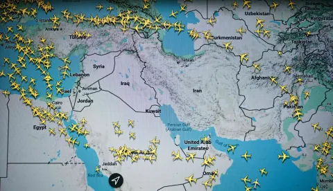 This photograph taken in Paris on March 1, 2026 shows a page on the Flightradar 24 website thats shows civilian flights avoiding Iranian and Iraqi sky. The biggest disruption to global air transport since the Covid pandemic continued on March 1, 2026, with thousands of flights affected and busy Middle Eastern hubs including Dubai and Doha shuttered as Iran lashed out after US-Israeli strikes. Iran, Iraq, Israel, Syria, Kuwait, Qatar and the United Arab Emirates had all announced at least partial closures of their skies Saturday after the US and Israel attacked Iran, bringing civilian air traffic over the Middle East to an abrupt halt. (Photo by Anna KURTH/AFP)