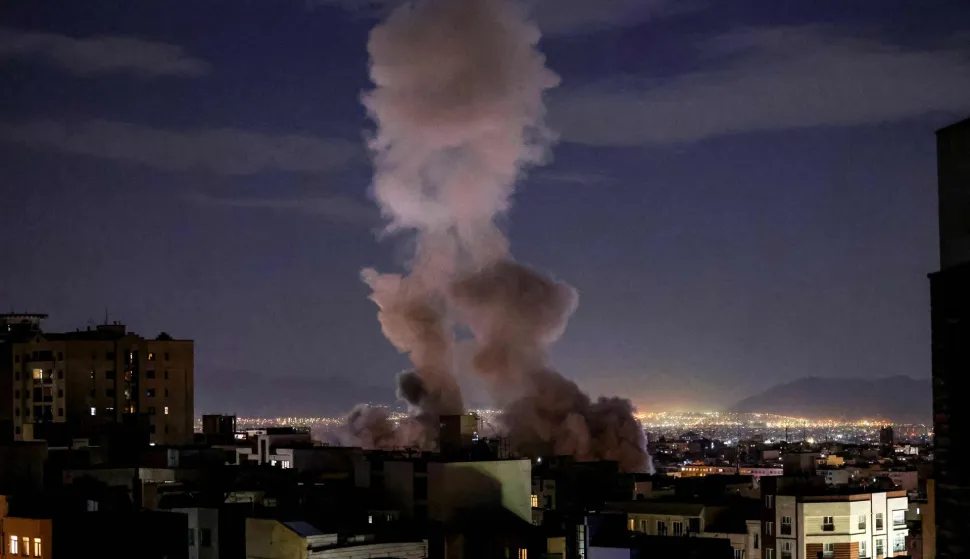 A smoke plume rises following a missile strike on a building in Tehran on March 1, 2026. The United States and Israel launched strikes against Iran on February 28, killing Iran's supreme leader and top military leaders, prompting authorities to retaliate with strikes on Israel and US bases across the Gulf. (Photo by ATTA KENARE/AFP)