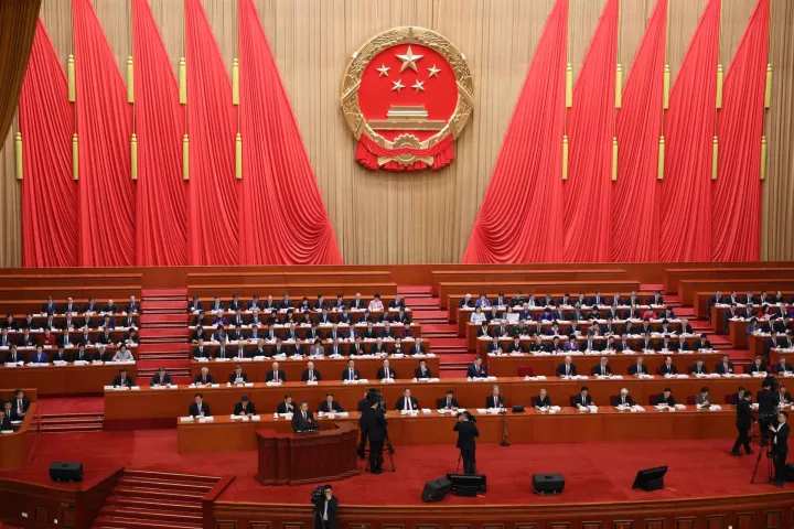 Chinese Premier Li Qiang delivers a work report during the opening session of the National People's Congress (NPC) at the Great Hall of the People in Beijing on March 5, 2026. (Photo by Florence Lo/POOL/AFP)