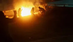 People are silhouetted against a fire as supporters of Iraqi Shi'ite armed groups attempt to move toward the U.S. embassy located in Baghdad's Green Zone following the Israel and U.S. strikes on Iran and the killing of Iran's Supreme Leader Ali Khamenei, in Baghdad, Iraq, March 1, 2026. REUTERS/Ahmed Saad Photo: AHMED SAAD/REUTERS