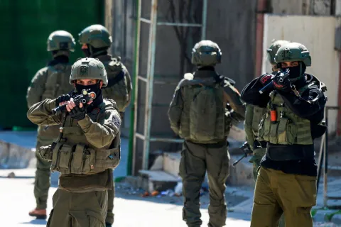 TOPSHOT - Israeli soldiers patrol a street during a military operation in the Askar refugee camp in eastern Nablus, Israeli-occupied West Bank, on March 2, 2026. (Photo by Jaafar ASHTIYEH/AFP)