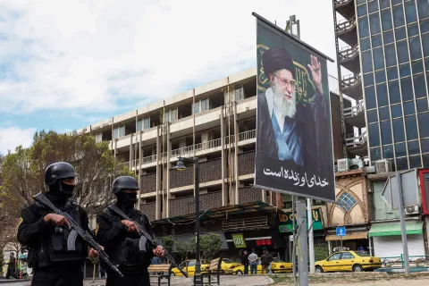 TOPSHOT - Members of Iranian security forces stand guard on a street next to a billboard of Iran?s supreme leader Ayatollah Ali Khamenei in Tehran on March 2, 2026. Israeli strikes on Lebanon killed at least 31 people on March 2, authorities said, following rocket fire from Tehran-backed militant group Hezbollah after the killing of Iran's supreme leader. (Photo by AFP)
