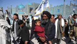 TOPSHOT - Afghan supporters gather to cheer for Taliban security personnel at the Hazrat-e-Ali Shrine, or the Blue Mosque in Mazar-i-Sharif on March 1, 2026 amid ongoing cross-border fighting between Pakistan and Afghanistan. Explosions were heard in the Afghan capital Kabul on March 1, AFP journalists said, with the Taliban government saying they were responding to aerial Pakistan attacks. (Photo by AFP)