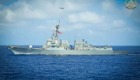 This handout photo taken on February 26, 2026 and released on February 27 by the Armed Forces of the Philippines-Public Affairs Office (AFP-PAO) shows US Arleigh Burke-class guided-missile destroyer USS Dewey (DDG 105) sailing as a MH-60R Seahawk helicopter hovers above during a joint military exercise in the disputed South China Sea. The Philippine, US and Japanese militaries this week conducted joint exercises near the Bashi Channel that separates the archipelago nation from Taiwan, officials said on February 27. Aircrafts from the three nations patrolled over the Philippines' northernmost Batanes islands in drills aimed at showcasing their "ability to operate seamlessly together in complex maritime environments," the Philippine military said in a statement. (Photo by Handout/Armed Forces of the Philippines-Public Affairs Office (AFP-PAO)/AFP)/-----EDITORS NOTE --- RESTRICTED TO EDITORIAL USE - MANDATORY CREDIT "AFP PHOTO/ARMED FORCES OF THE PHILIPPINES-PUBLIC AFFAIRS OFFICE (AFP-PAO)" - NO MARKETING - NO ADVERTISING CAMPAIGNS - DISTRIBUTED AS A SERVICE TO CLIENTS