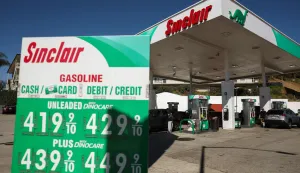 A sign with current gas prices is displayed at a gas station in Los Angeles, California on March 2, 2026. Energy prices surged on March 2 as the war in the Middle East led to outages of key energy production operations. In parallel, energy markets are also absorbing a de facto halt to traffic in the Strait of Hormuz, through which about 20 percent of global supply of oil and liquid natural gas travel.The waterway has not technically been closed, but major maritime companies have suspended travel through it as insurance costs soar amid heightened risk. (Photo by Patrick T. Fallon/AFP)